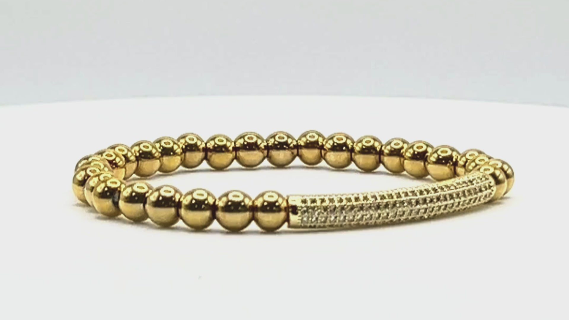 Load video: T. Randall Jewelry 18K Gold Plated Stretch Bracelet With Pave Focal